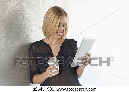 Smiling woman using tablet computer View Large Photo Image Stock Photography - Smiling woman using tablet computer. Fotosearch