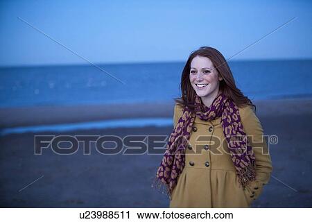Smiling woman walking on beach View Large Photo Image Stock Image - Smiling woman walking on beach. Fotosearch