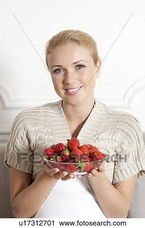 Smiling woman with bowl of strawberries View Large Photo Image Stock Image - Smiling woman with bowl of strawberries. Fotosearch