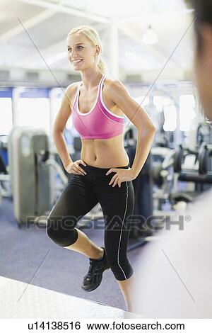 Smiling woman working out in gym View Large Photo Image Stock Photograph - Smiling woman working out in gym. Fotosearch