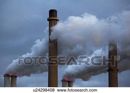 Stock Photo - Smoke pouring from factory smokestacks. Fotosearch
