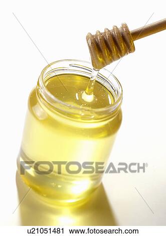 Stirrer in jar of honey View Large Photo Image Stock Image - Stirrer in jar of honey. Fotosearch