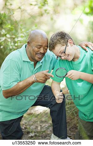 Student examining plants with teacher View Large Photo Image Stock Image - Student examining plants with teacher. Fotosearch
