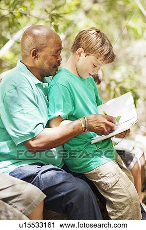 Student examining plants with teacher View Large Photo Image Stock Image - Student examining plants with teacher. Fotosearch