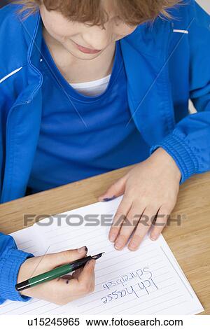 Stock Photography - Student practicing handwriting in class. Fotosearch