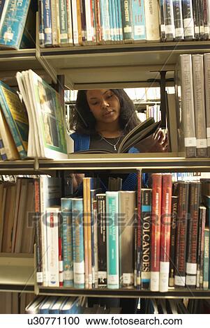 Student reading in library View Large Photo Image Stock Image - Student reading in library. Fotosearch