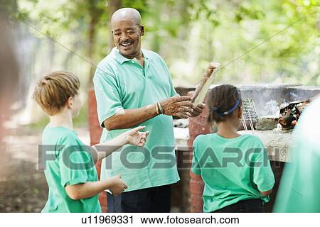 Stock Image - Students playing outside with teacher. Fotosearch