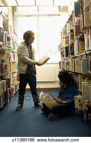Stock Photograph - Students reading in library. Fotosearch