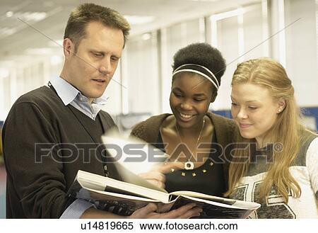 Students reading with teacher in library View Large Photo Image Stock Photography - Students reading with teacher in library. Fotosearch