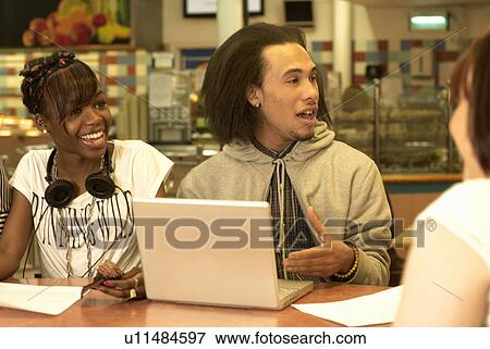 Students using laptop in cafe View Large Photo Image Stock Photo - Students using laptop in cafe. Fotosearch
