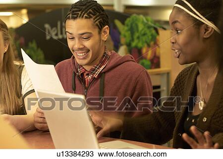 Students working together at desk View Large Photo Image Stock Image - Students working together at desk. Fotosearch