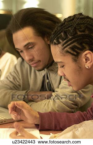 Students working together at desk View Large Photo Image Stock Image - Students working together at desk. Fotosearch