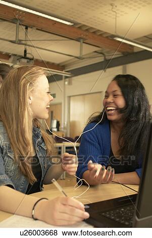 Students working together at desk View Large Photo Image Stock Photo - Students working together at desk. Fotosearch