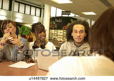 Stock Photo - Students working together in cafe. Fotosearch