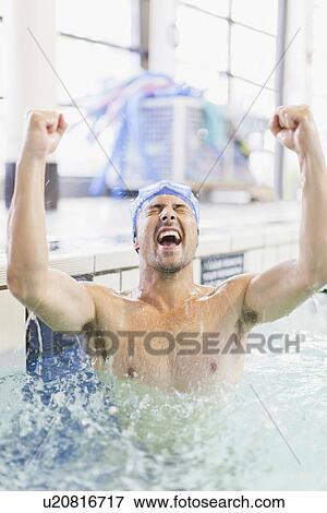 Stock Photo - Swimmer cheering in pool. Fotosearch