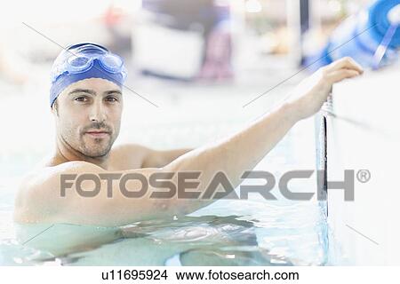 Picture - Swimmer climbing out of pool. Fotosearch