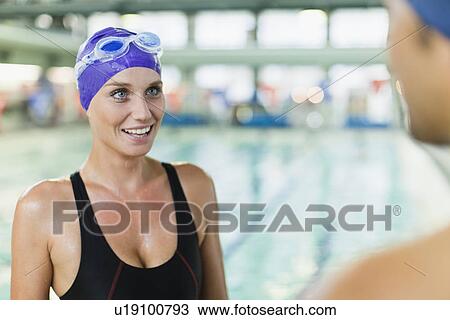 Swimmers talking by pool View Large Photo Image Stock Image - Swimmers talking by pool. Fotosearch