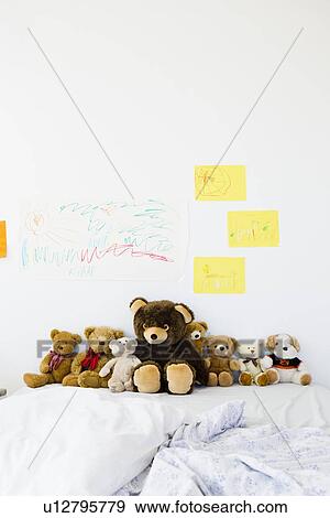 Teddy bears and childs drawings on bed View Large Photo Image Stock Photo - Teddy bears and childs drawings on bed. Fotosearch