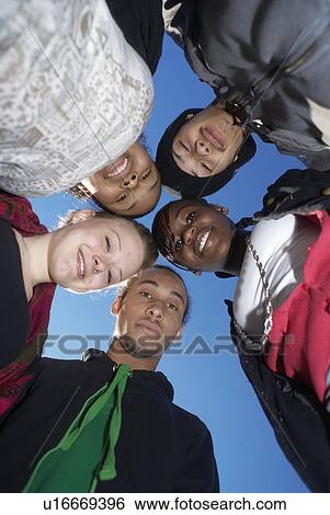 Teenagers standing together in circle View Large Photo Image Stock Photograph - Teenagers standing together in circle. Fotosearch