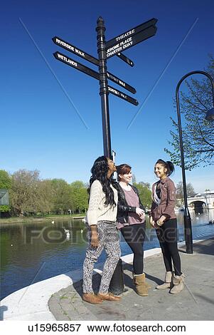 Stock Photo - Teenagers talking on urban waterfront. Fotosearch