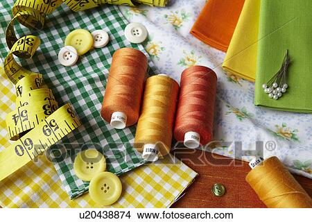 Thread, buttons, measuring tape on desk View Large Photo Image Picture - Thread, buttons, measuring tape on desk. Fotosearch