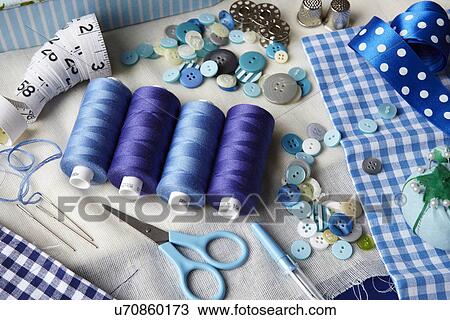 Thread, buttons, measuring tape on desk View Large Photo Image Stock Image - Thread, buttons, measuring tape on desk. Fotosearch