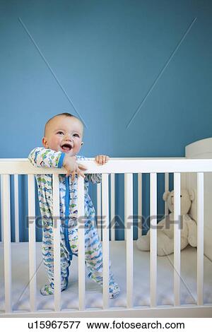 Stock Photo - Toddler standing up in crib. Fotosearch