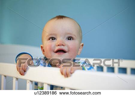 Toddler standing up in crib View Large Photo Image Stock Photograph - Toddler standing up in crib. Fotosearch