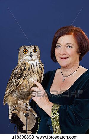 Trainer holding owl on arm View Large Photo Image Stock Image - Trainer holding owl on arm. Fotosearch