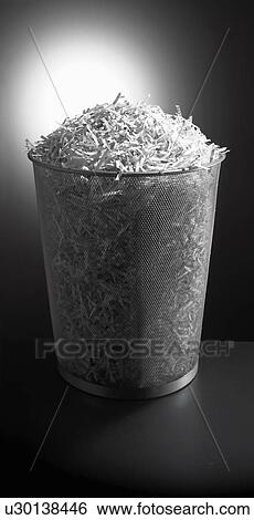 Trash can full of shredded paper View Large Photo Image Stock Photograph - Trash can full of shredded paper. Fotosearch