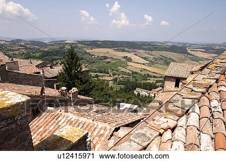 Stock Image - Village roofs on rural hillside. Fotosearch