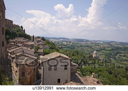 Stock Image - Village roofs on rural hillside. Fotosearch