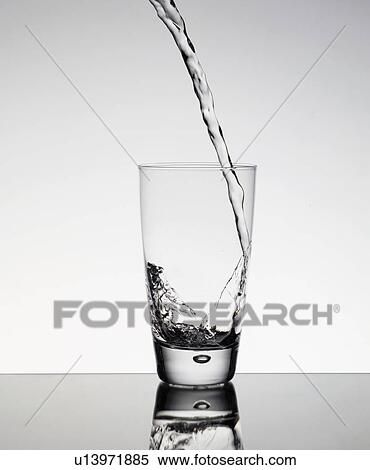 Stock Photography - Water pouring into glass. Fotosearch
