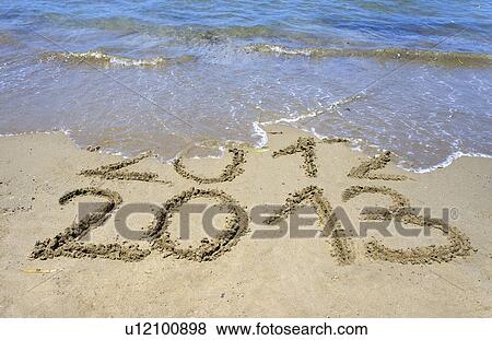 Waves washing away ì2012î in sand View Large Photo Image Stock Photo - Waves washing away ì2012î in sand. Fotosearch
