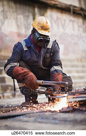 Stock Photography - Welder at work on dry dock. Fotosearch