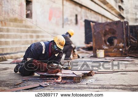 Stock Photo - Welders at work on dry dock. Fotosearch