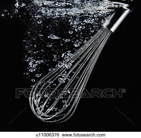 Stock Photograph - Whisk plunging into water. Fotosearch