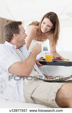 Woman bringing husband breakfast tray View Large Photo Image Stock Photo - Woman bringing husband breakfast tray. Fotosearch