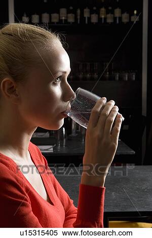 Woman drinking water in cafe View Large Photo Image Stock Photography - Woman drinking water in cafe. Fotosearch