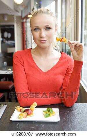 Woman eating plate of food in cafe View Large Photo Image Stock Photo - Woman eating plate of food in cafe. Fotosearch