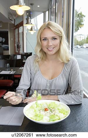 Woman eating salad in cafe View Large Photo Image Stock Image - Woman eating salad in cafe. Fotosearch