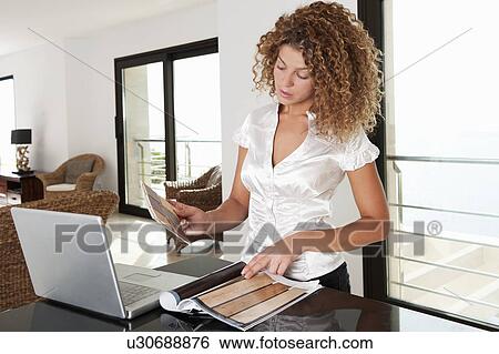 Woman examining swatches in home View Large Photo Image Stock Photograph - Woman examining swatches in home. Fotosearch