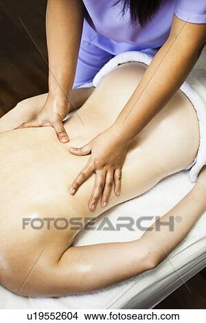 Woman having back massage in spa View Large Photo Image Picture - Woman having back massage in spa. Fotosearch