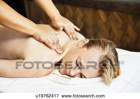 Woman having back massage in spa View Large Photo Image Stock Photo - Woman having back massage in spa. Fotosearch