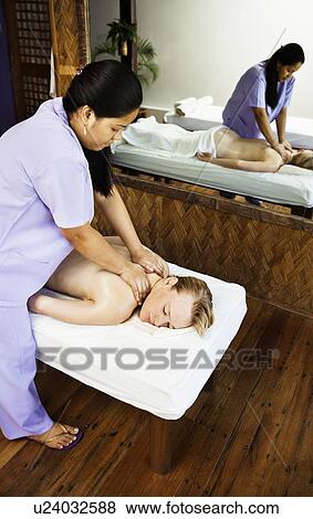 Stock Photo - Woman having back massage in spa. Fotosearch