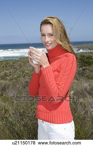 Woman having cup of coffee outdoors View Large Photo Image Stock Photo - Woman having cup of coffee outdoors. Fotosearch