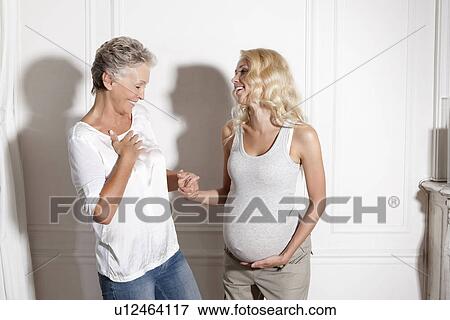 Woman holding pregnant daughters hand View Large Photo Image Stock Photo - Woman holding pregnant daughters hand. Fotosearch
