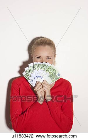 Woman holding stack of Euros View Large Photo Image Stock Image - Woman holding stack of Euros. Fotosearch