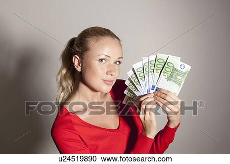 Woman holding stack of Euros View Large Photo Image Stock Image - Woman holding stack of Euros. Fotosearch