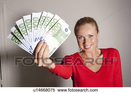 Woman holding stack of Euros View Large Photo Image Stock Photography - Woman holding stack of Euros. Fotosearch